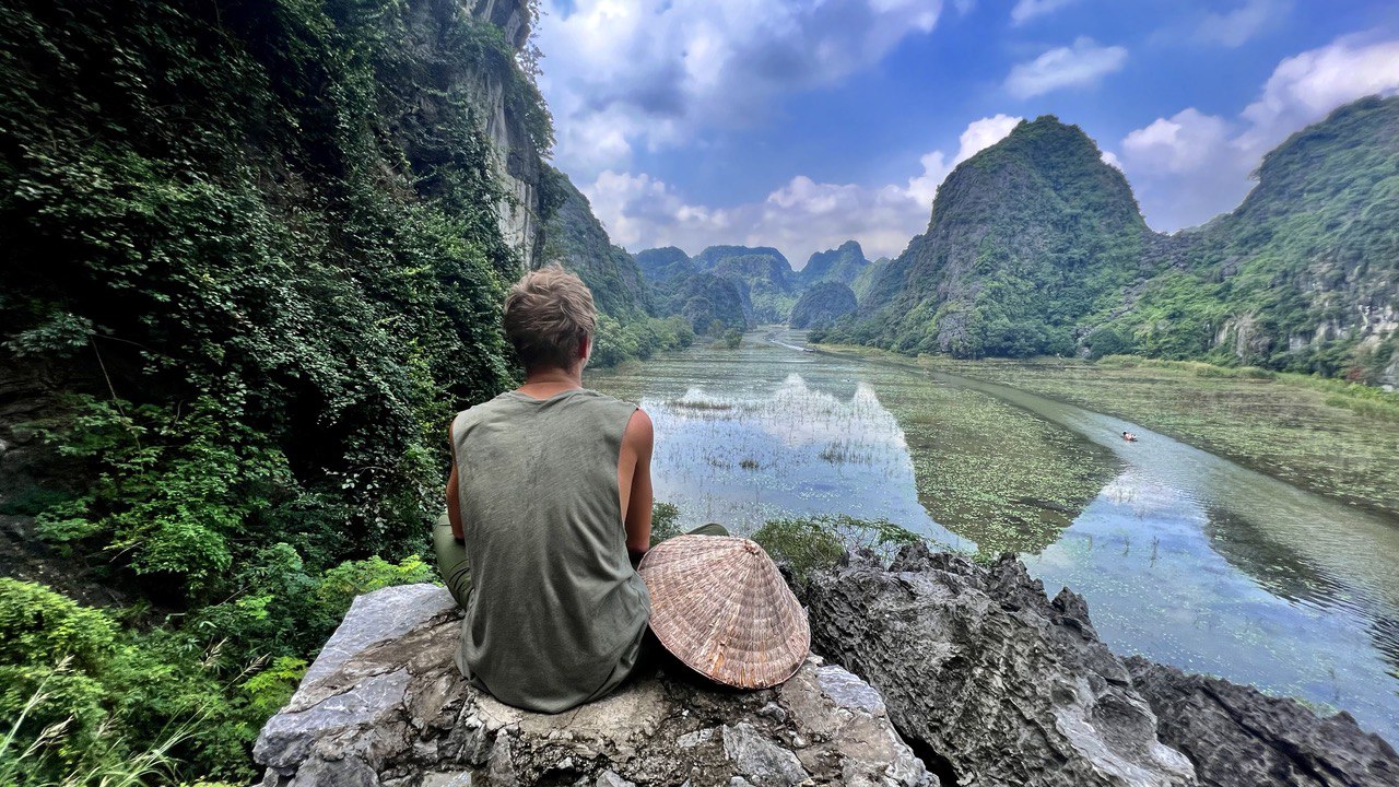 A traveler against the mountains and the river in Vietnam